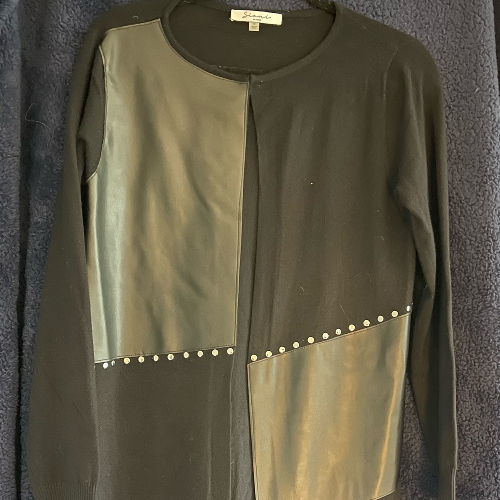 Black sweater with black leather and silver stud accents. 33” length.